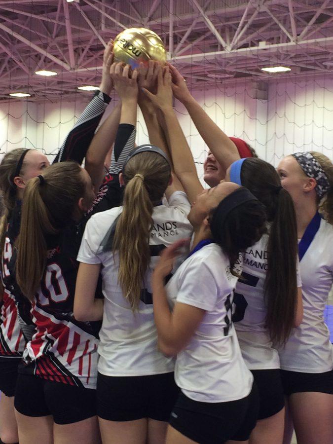 The team holds up the championship golden volleyball and begin to fathom their achievement, as they receive a bid to the national championship.