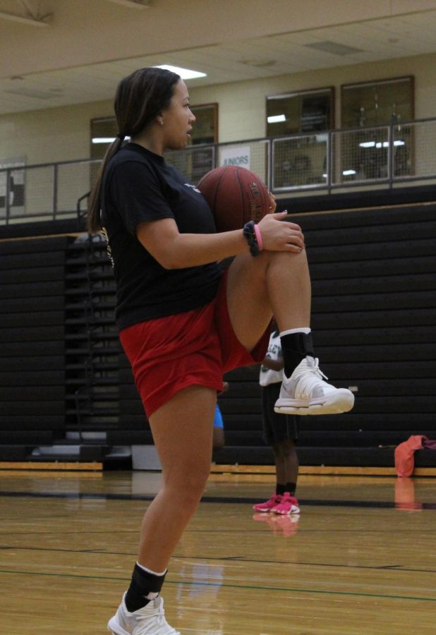 Warming up for basketball practice Nov. 4, senior Emilyn Richardson is preparing for practice. Joining the team this year, Richardson is eager to get the season started. “It’s going to be a fun and exciting season. Yes, we will have some ups and downs but that’s just part of it.” 
 