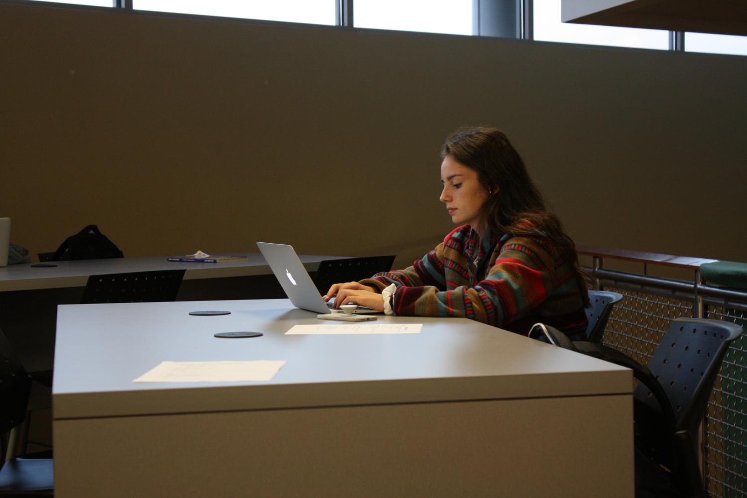 Before school in the Falcon's Nest, senior Brooklyn Hannan works on homework on Sept.18. Hannan often used the space to work on her Exhibition project.