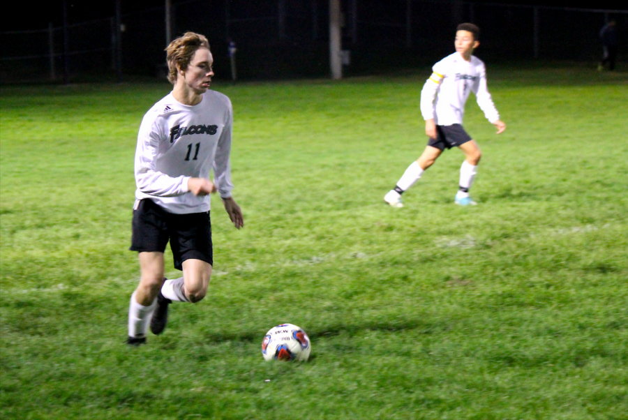 Taking the ball, junior Jared Kinate dribbles down the field against St. Joseph Central High School Oct. 17. Varsity lost 0-2. The season is good so far. Ive had a lot of fun, the team this year has a good energy, and hopefully we can make it far in post season play, said Kinate.
