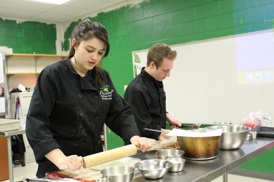 In culinary team practice Nov. 15, junior Michaela McCarthy and senior Joey Daniels practice the entree portion of their competition by preparing the ingredients. This was Daniels first year on the team. We are in the test phase of competition right now, said McCarthy.