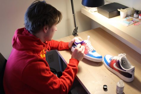 At his desk, junior Keagan Kooi puts the finishing touches on a new pair of shoes. “It’s something I enjoy doing. I think it’s cool to put your own personal touch on a pair of shoes,” said Kooi.