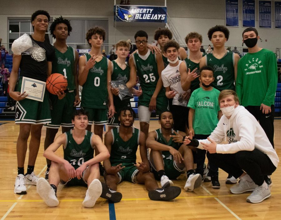 The+boys+basketball+team+celebrates+after+a+67-54+win+in+the+C.W.+Stessman+Invitational+championship+game+against+Liberty+High+School+at+Liberty.+Staley%2C+who+was+ranked+No.+4+in+the+Kansas+City+area+by+810+Sports%2C+played+Liberty%2C+who+was+ranked+No.+5.+%E2%80%9CIt+felt+really+great+because+we+don%E2%80%99t+really+get+to+play+Liberty%2C+and+they%E2%80%99re+always+good+competition%2C+and+it%E2%80%99s+really+fun%2C%E2%80%9D+said+junior+guard+Asa+Bridges.