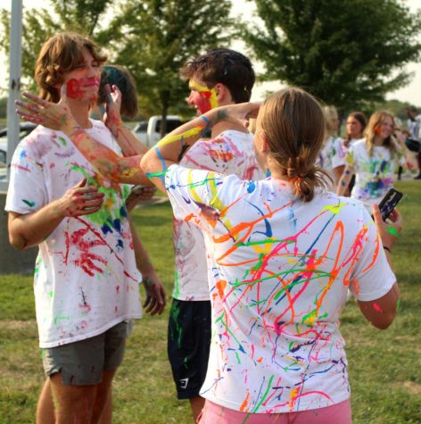 Taking the paint Sept. 10 at the paint war, sophomores Bryan Richards and Jakob Zahabi participate at The Pavilion. When the painting started, Richards joined in too. “I was feeling pretty happy because I was with my friends, and I was having a good time,” Richards said.