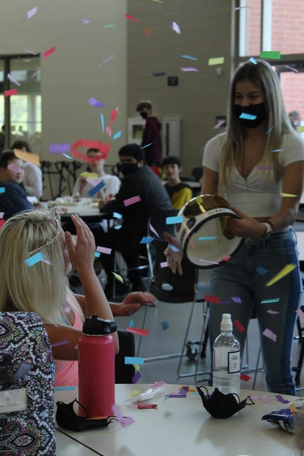 During third lunch, senior Hailey Gifford celebrates the top five homecoming queen announcements.