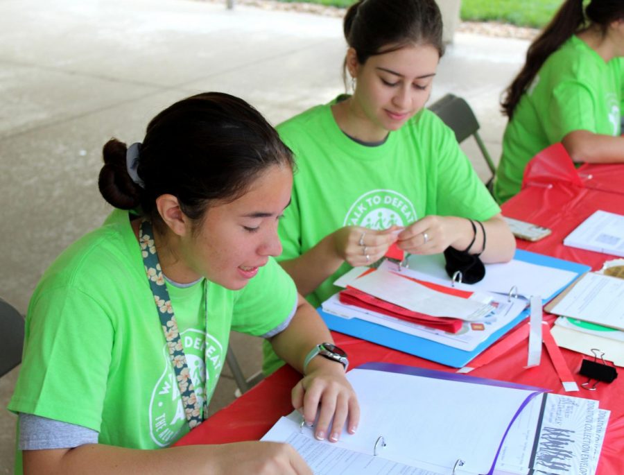 At the walk, juniors Kiyoko Nakano and Gabriela Hejde help at the registration table. Nakano collected donation forms and passed out wristbands to walkers. “My favorite part was getting to interact with the families of those who have been affected by it and those who actually have ALS and getting to hear their stories,” Nakano said.