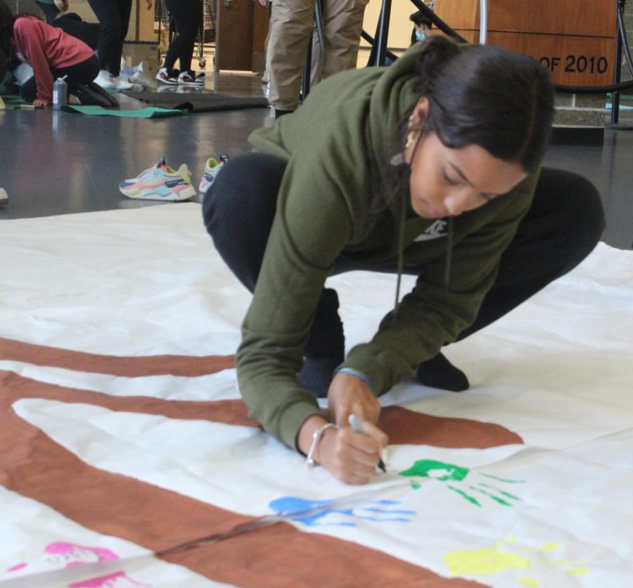 During the Falcon Time Diversity Club meeting Oct. 15, senior Kiara Esquilin paints a sign. The club planned to host the schools first-ever Diversity Week Oct. 18-22.