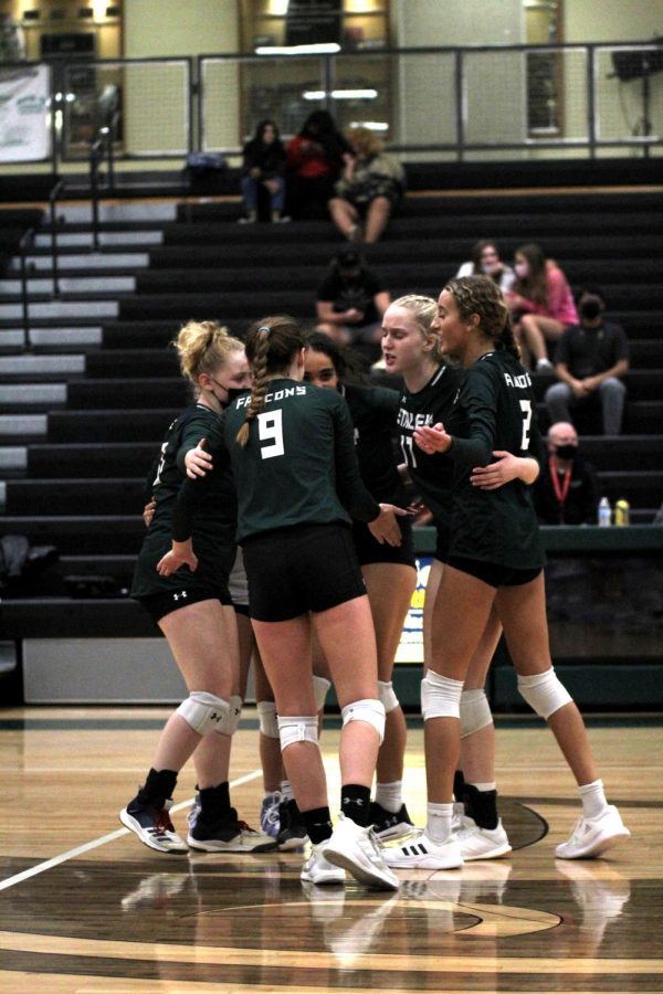 Huddling together, seniors Macy Tauke, Emily Burlington, juniors Gabby Ramirez, Ady Horn and freshman Mya Schirk celebrate after a point during their 0-3 loss to Park Hill South Oct. 18. Varsity volleyball was battling their way through the district playoffs at the time of printing. “We have made connections with the team, and we have fun with each other,” Burlington said.