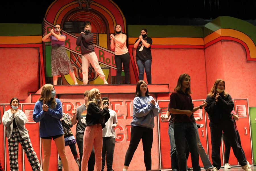 The cast of Grease rehearses choreography for the show. Many hours of practice were put in at rehearsals. Were working together as a team really well and were all helping each other, senior Katie Holloway said. 
