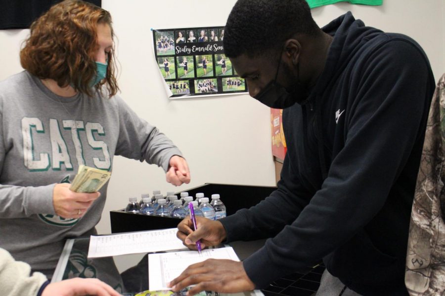 During Falcon Time Dec. 13, business teacher Kelly Rule and senior Andrew Richardson count money. 