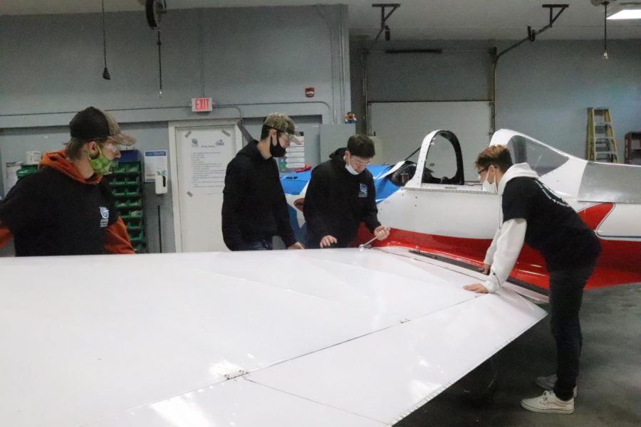 At Northland Career Center Dec. 18, students in the Aviation Technology department observe an airplane before starting to work on it.