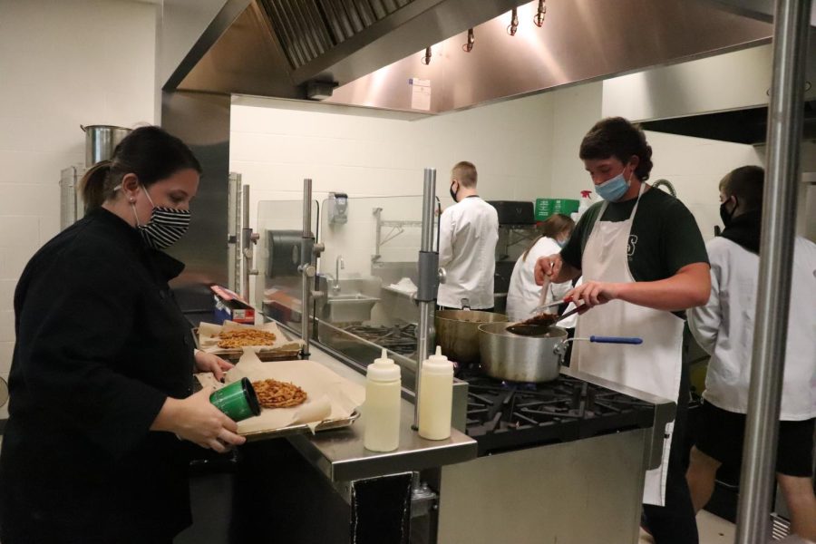 In the existing kitchen, FACS teacher Rachel Mitchell works with students in Prostart 1 Oct. 25.