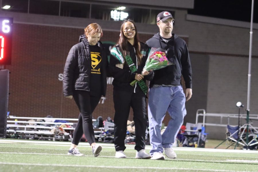 Senior Jenna Reukmuang is escorted by her host parents. 