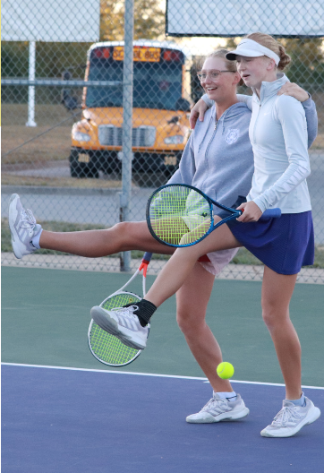 On the court, sisters senior Ava Gates and sophomore Ella Gates dance Sept. 30 at Park Hill High School during individual districts. Varsity won 6-3. “Having my sister be my doubles partner this year has made me become a stronger player,” Gates said. 