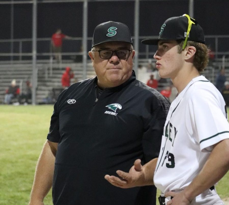 Coach David Wilson talks to sophomore Brody Irlbeck during the 3-1 win against Park Hill High School April 3.