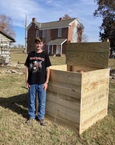 Senior Brandon Kelly stands next to his Eagle Scout project. 