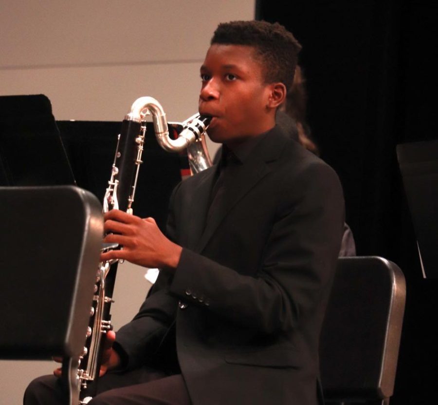 As part of the Falcon Brigade, junior Ralph Yarl plays the saxophone at the Winter Concert Dec. 6 in the Performing Arts Center.