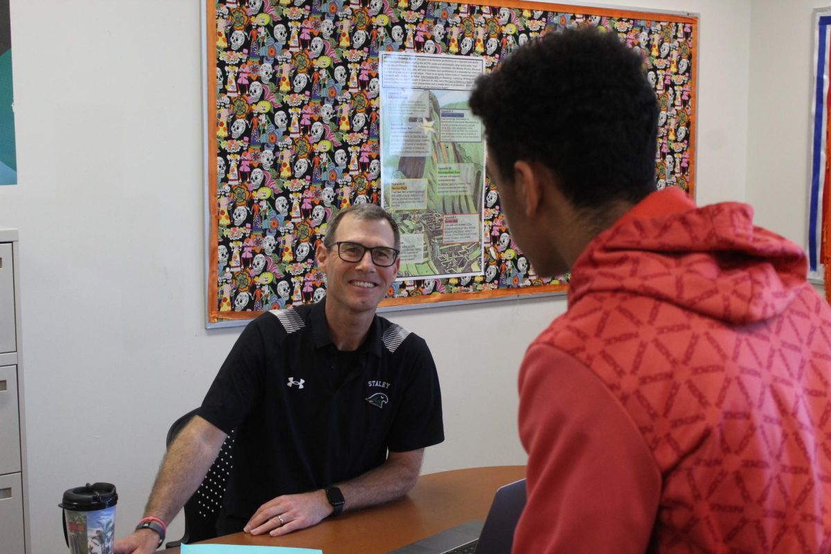 Spanish teacher Christopher Carey speaks to a student.