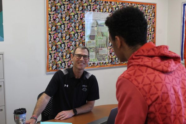 Spanish teacher Christopher Carey speaks to a student.