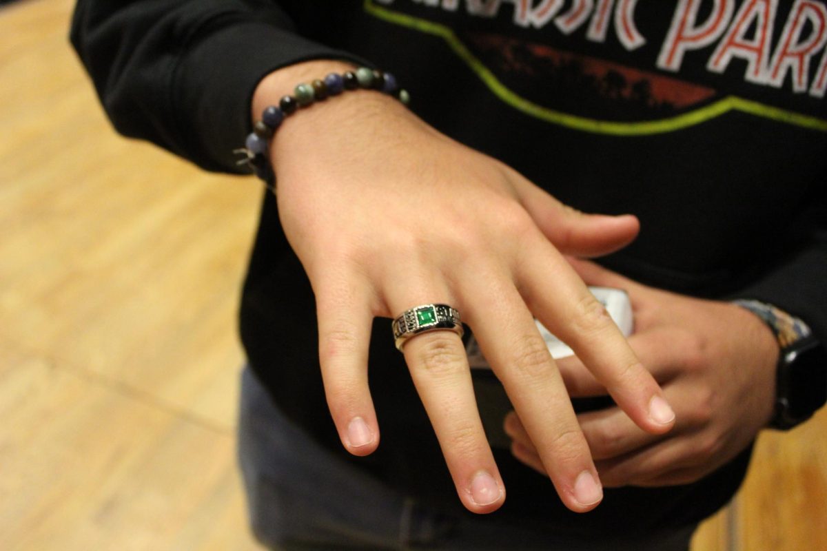 A sophomore shows off their ring.