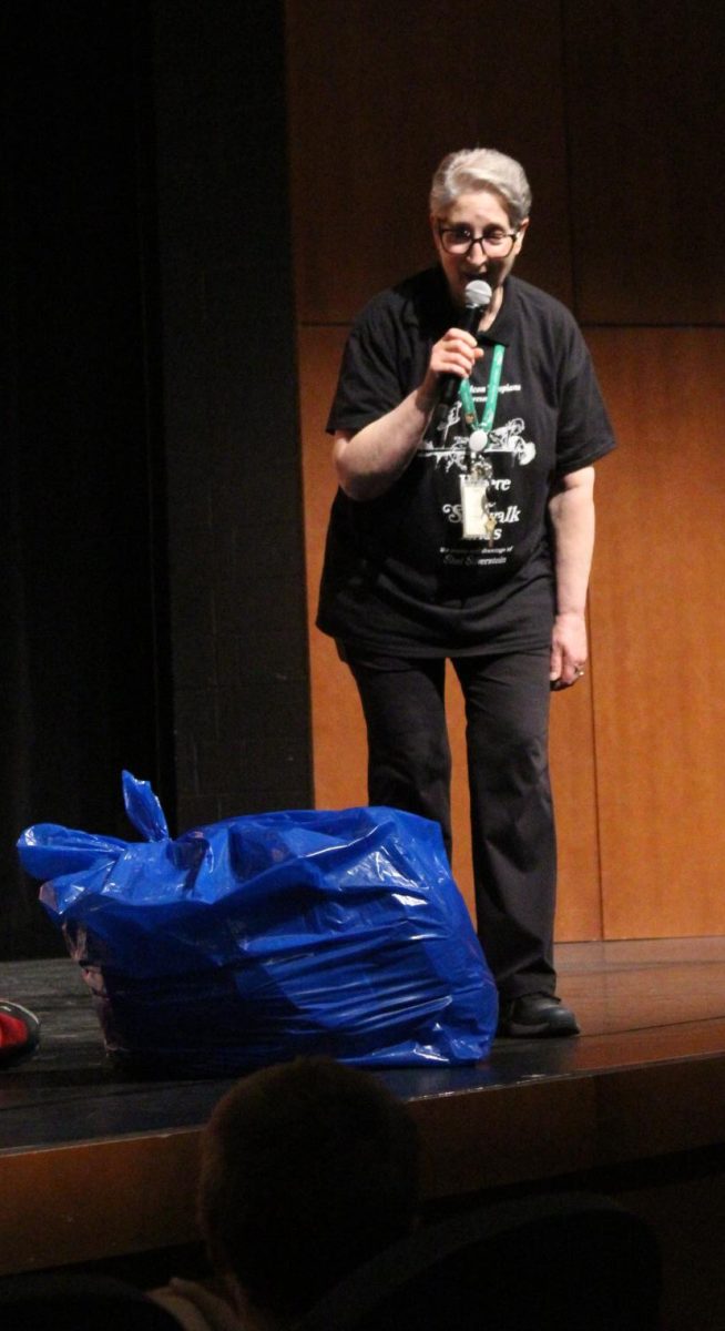 Theater teacher Danielle Trebus speaks to the audience at the matinee presentation of "Where the Sidewalk Ends" April 24.