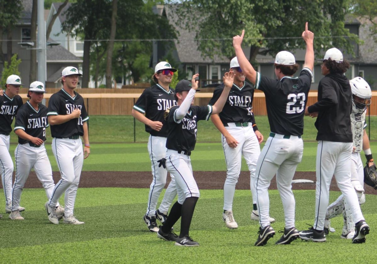 The varsity baseball team celebrates beating Lee's Summit High School 2-1 May 31 in the state quarterfinals.