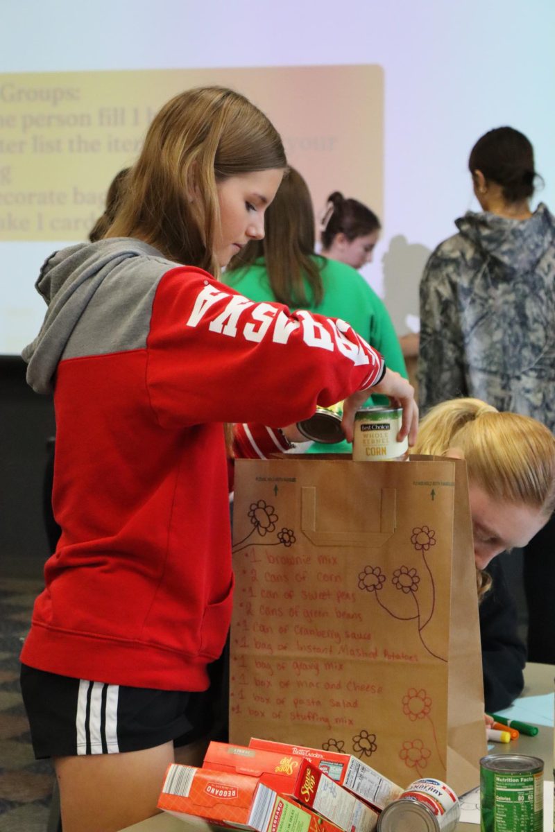 The Women's Empowerment Club packs groceries from donations to the food drive Nov. 21.