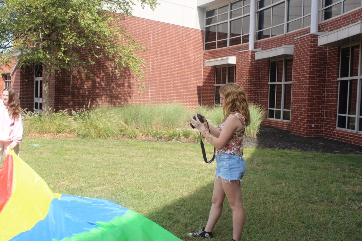 Talia Brown practices photography at a Jostens photography workshop Aug. 27 at Staley High School.