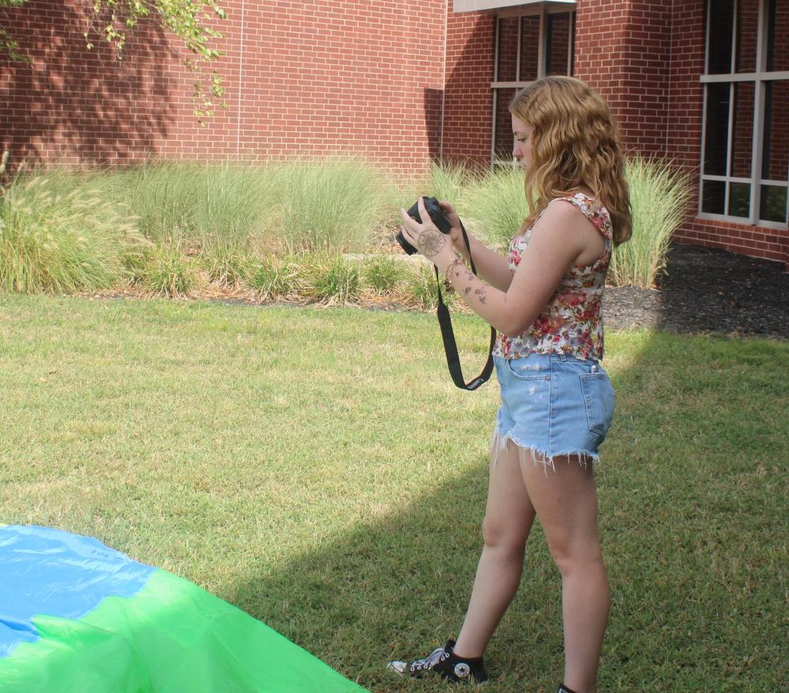 Talia Brown practices photography at a Jostens photography workshop Aug. 27 at Staley High School.